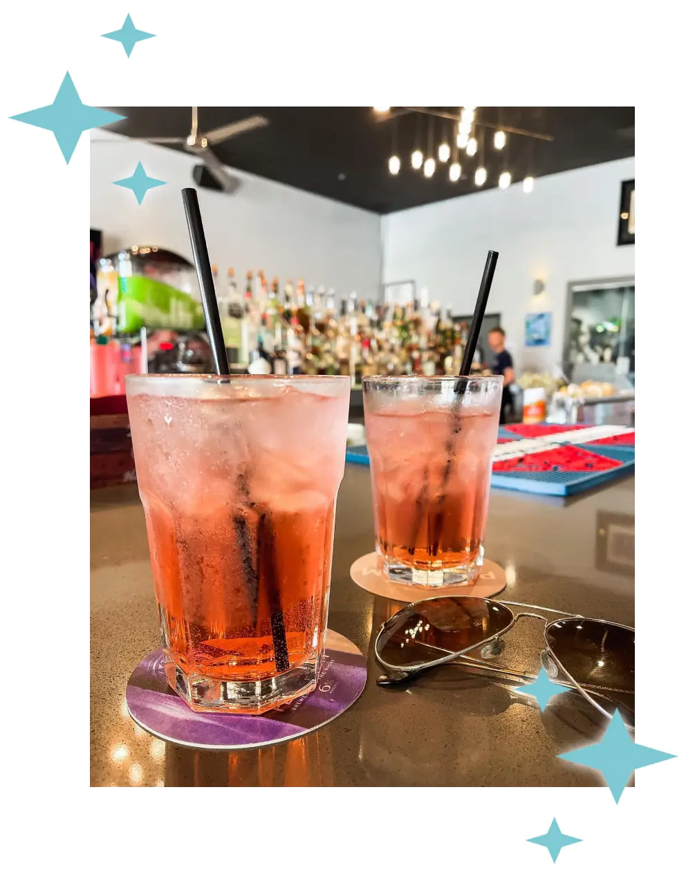 A picture of two pink cocktails on a table at The Roost.